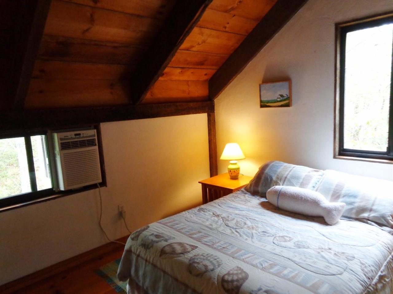 200 Gull Pond Road Wellfleet, MA 02667 - Photo 27 of 35 a bedroom with a bed and a window