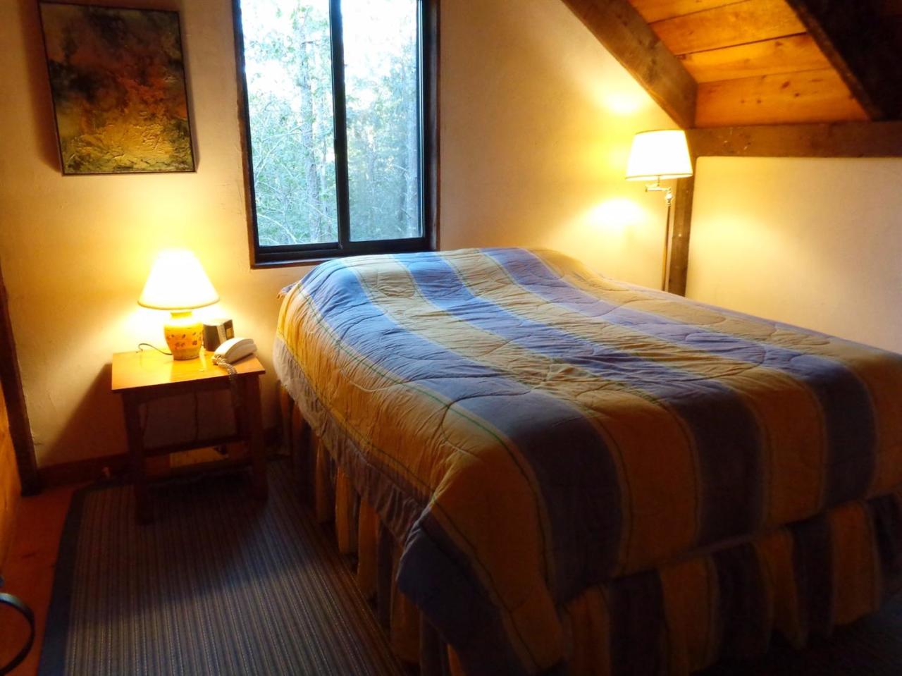 200 Gull Pond Road Wellfleet, MA 02667 - Photo 29 of 35 a bedroom with a bed lamp and a large window