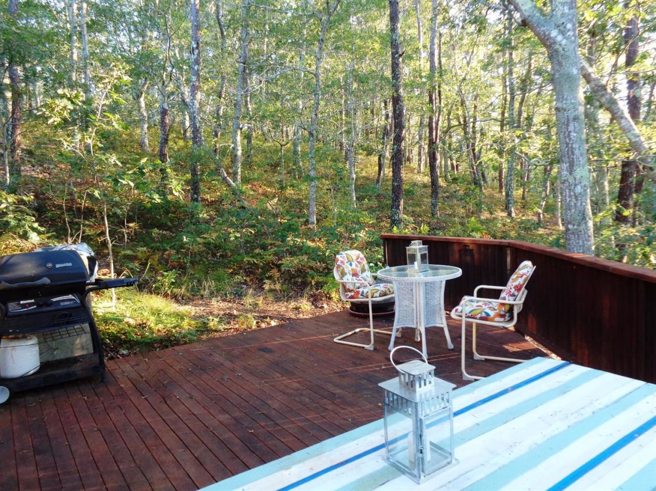200 Gull Pond Road Wellfleet, MA 02667 - Photo 10 of 35 a view of a patio with table and chairs and wooden floor