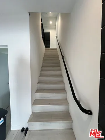 a view of a kitchen with a sink and a refrigerator