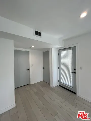 an empty room with closet and bathroom