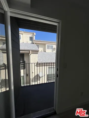 a porch with table and chairs