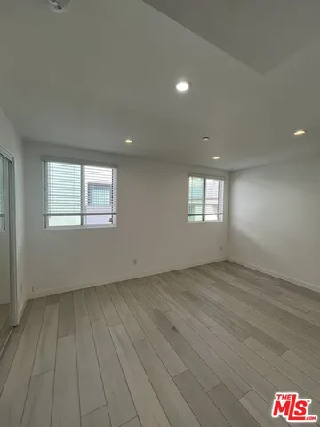 an empty room with windows and closet