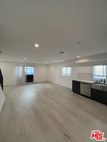 a view of hallway with wooden floor