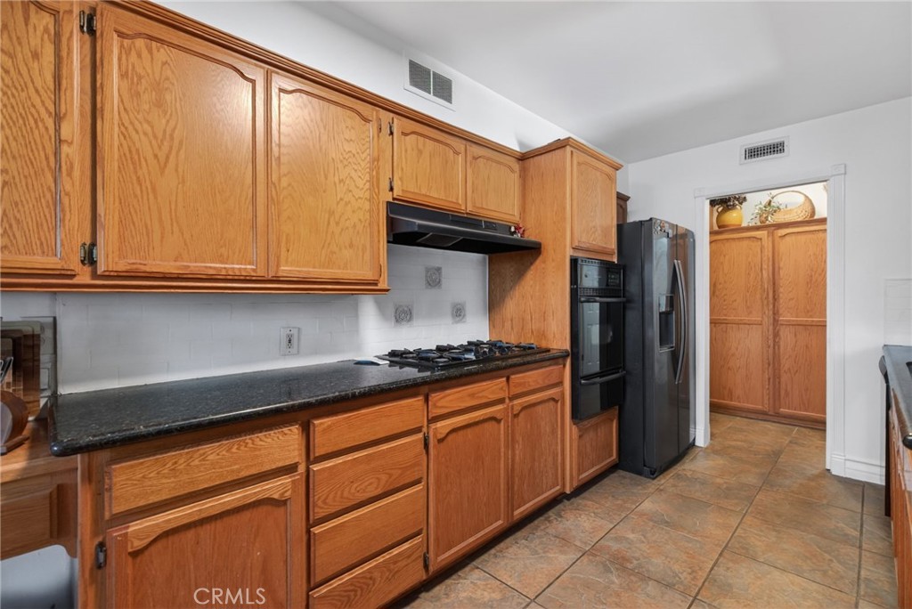 4194 Euclid Court Riverside, CA 92504 - Photo 10 of 29 Solid counter tops, gas cook top, and large pantry. And refrigerator stays.