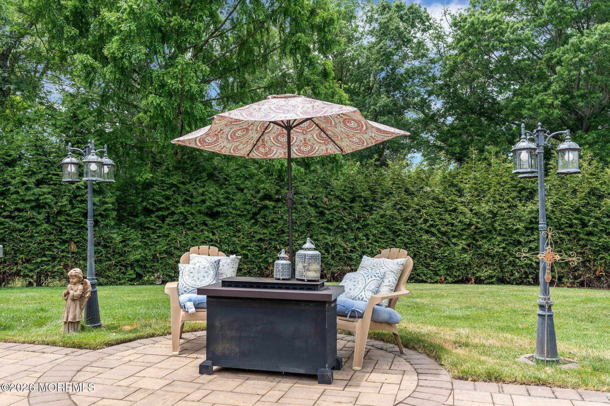 8 Owens Road Marlboro, NJ 07746 - Photo 38 of 39 a view of a patio with a table and chairs under an umbrella