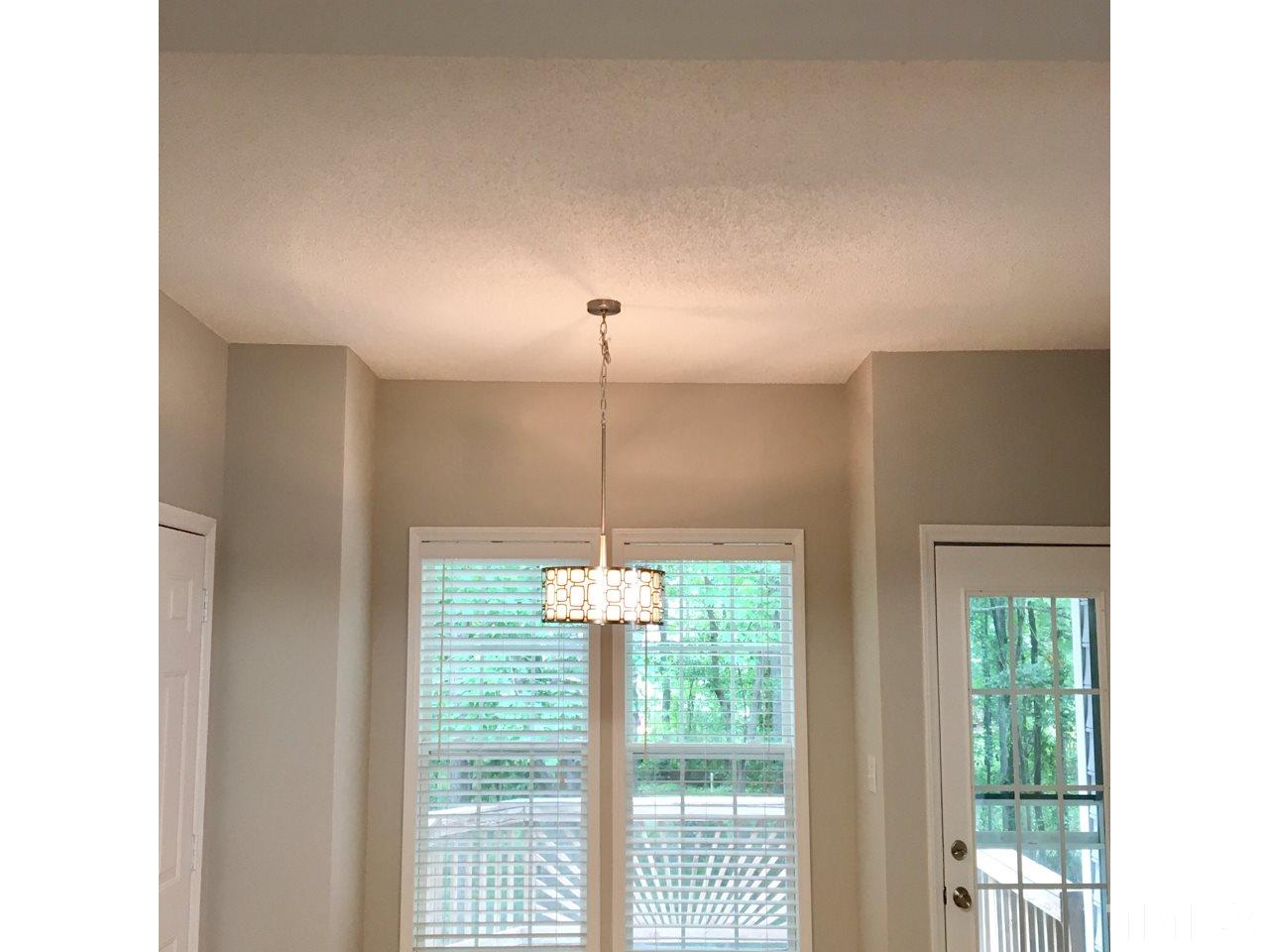 1410 Big Leaf Loop Apex, NC 27502 - Photo 6 of 20 a dining room with a window and chandelier