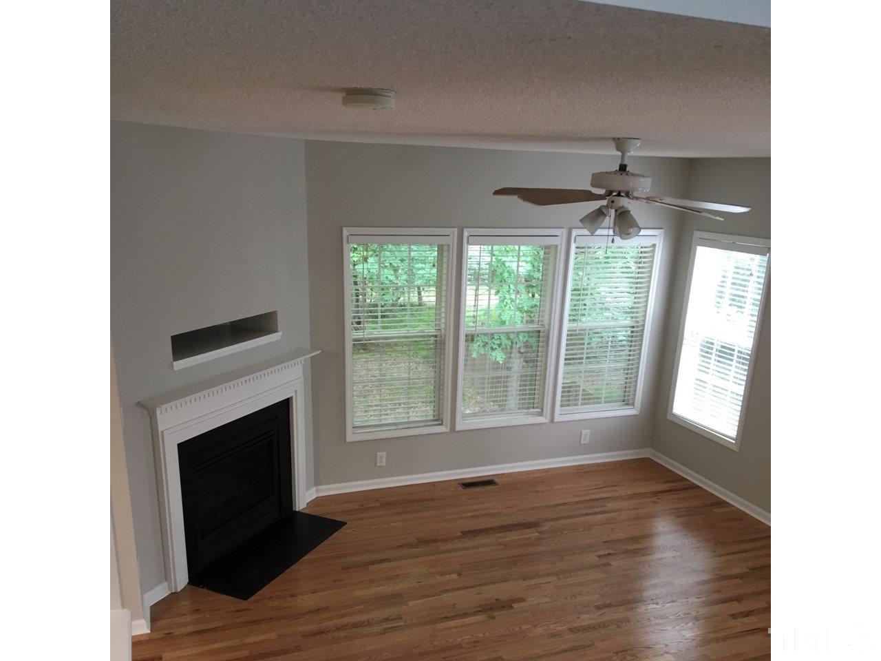 1410 Big Leaf Loop Apex, NC 27502 - Photo 7 of 20 a view of an empty room with wooden floor and a window