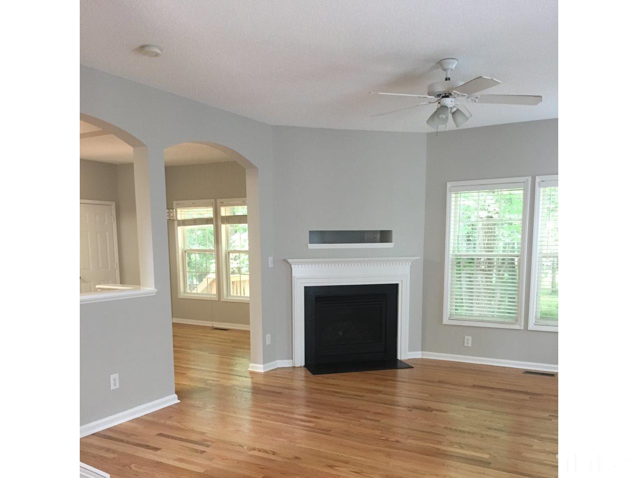 1410 Big Leaf Loop Apex, NC 27502 - Photo 8 of 20 a view of an empty room with window and fire place
