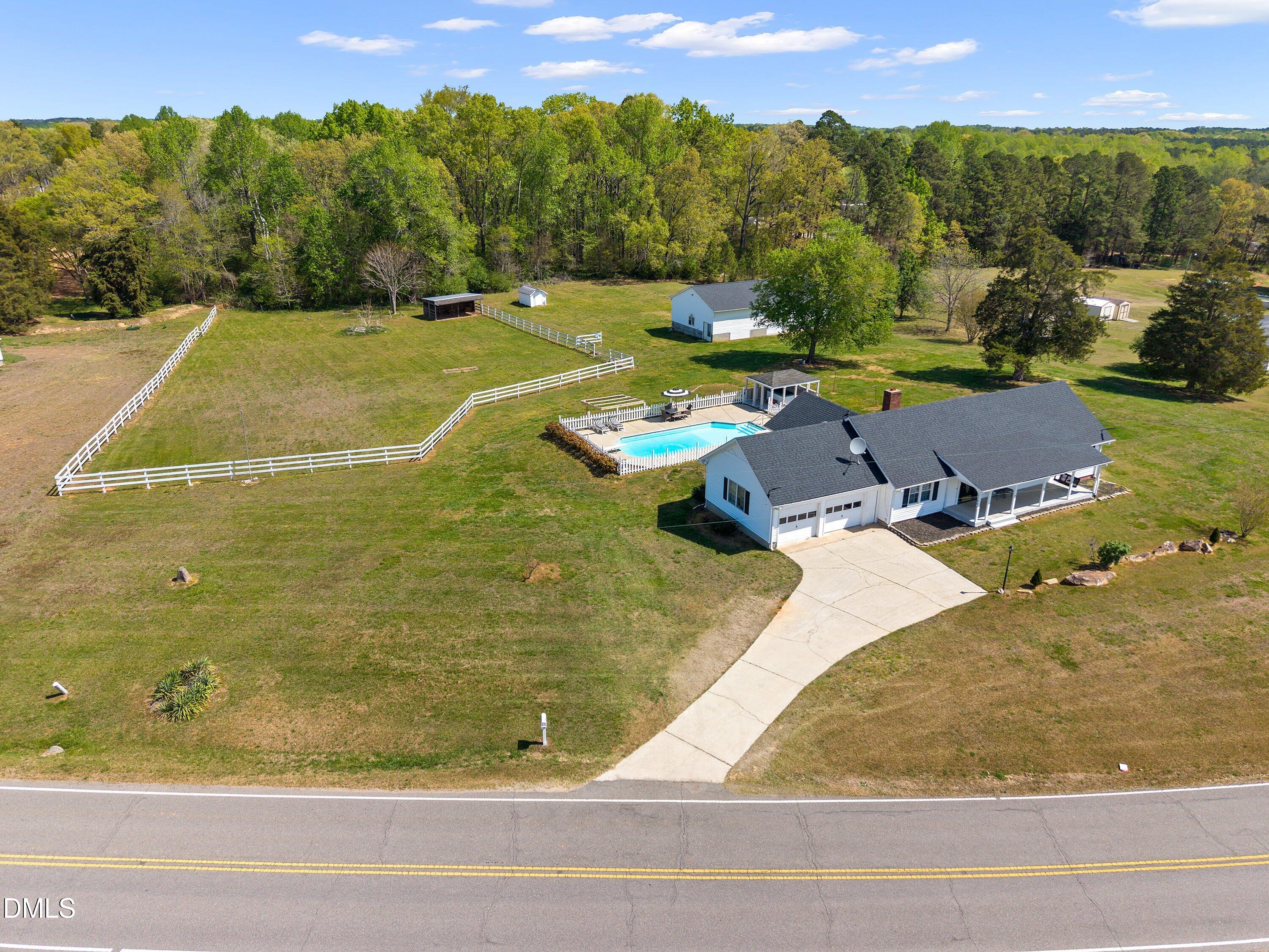 1899 Stewart Farm Road Henderson, NC 27537 - Photo 1 of 27 a view of a swimming pool with a yard and outdoor seating