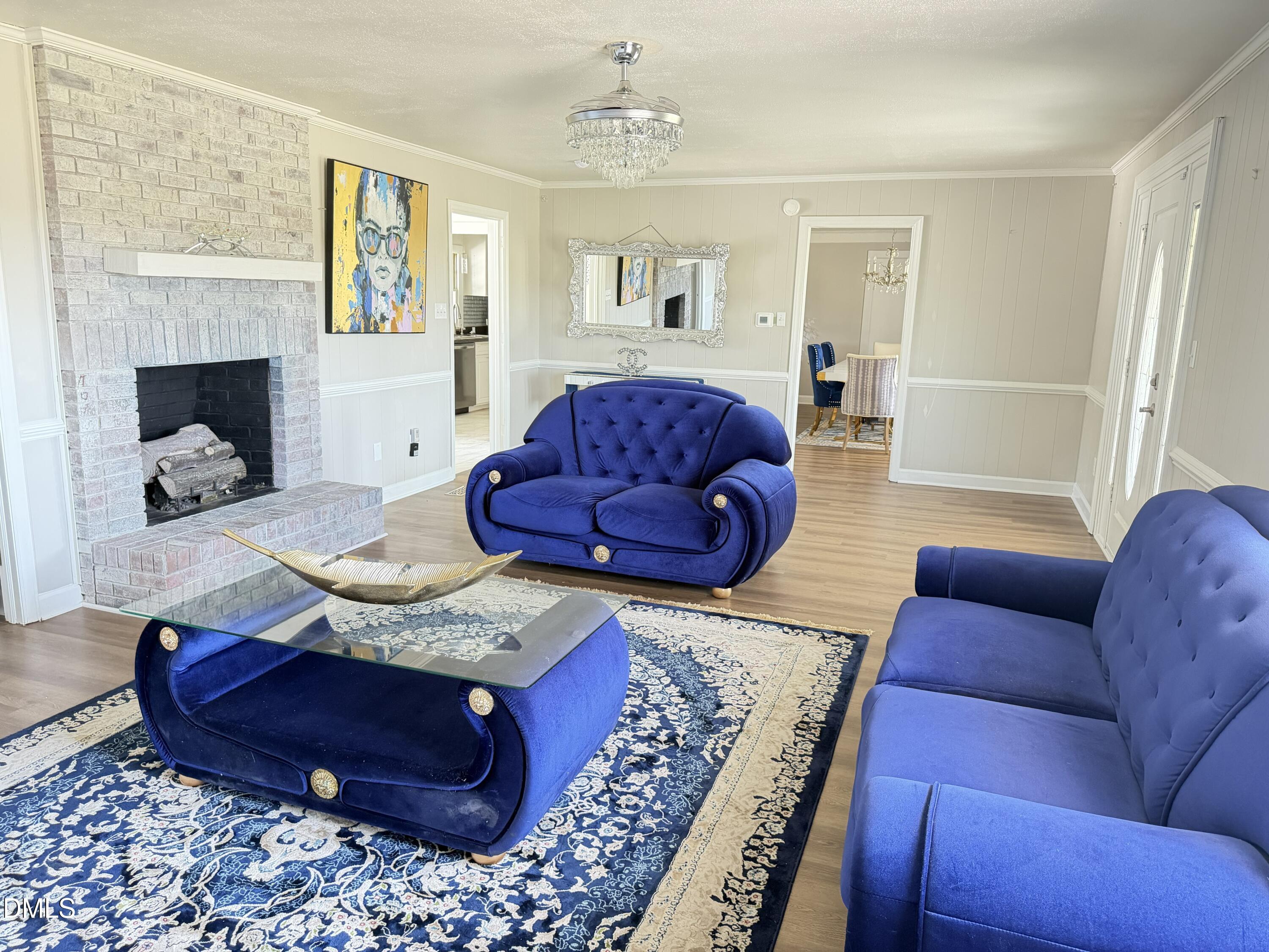 1899 Stewart Farm Road Henderson, NC 27537 - Photo 11 of 27 a living room with furniture and a fireplace
