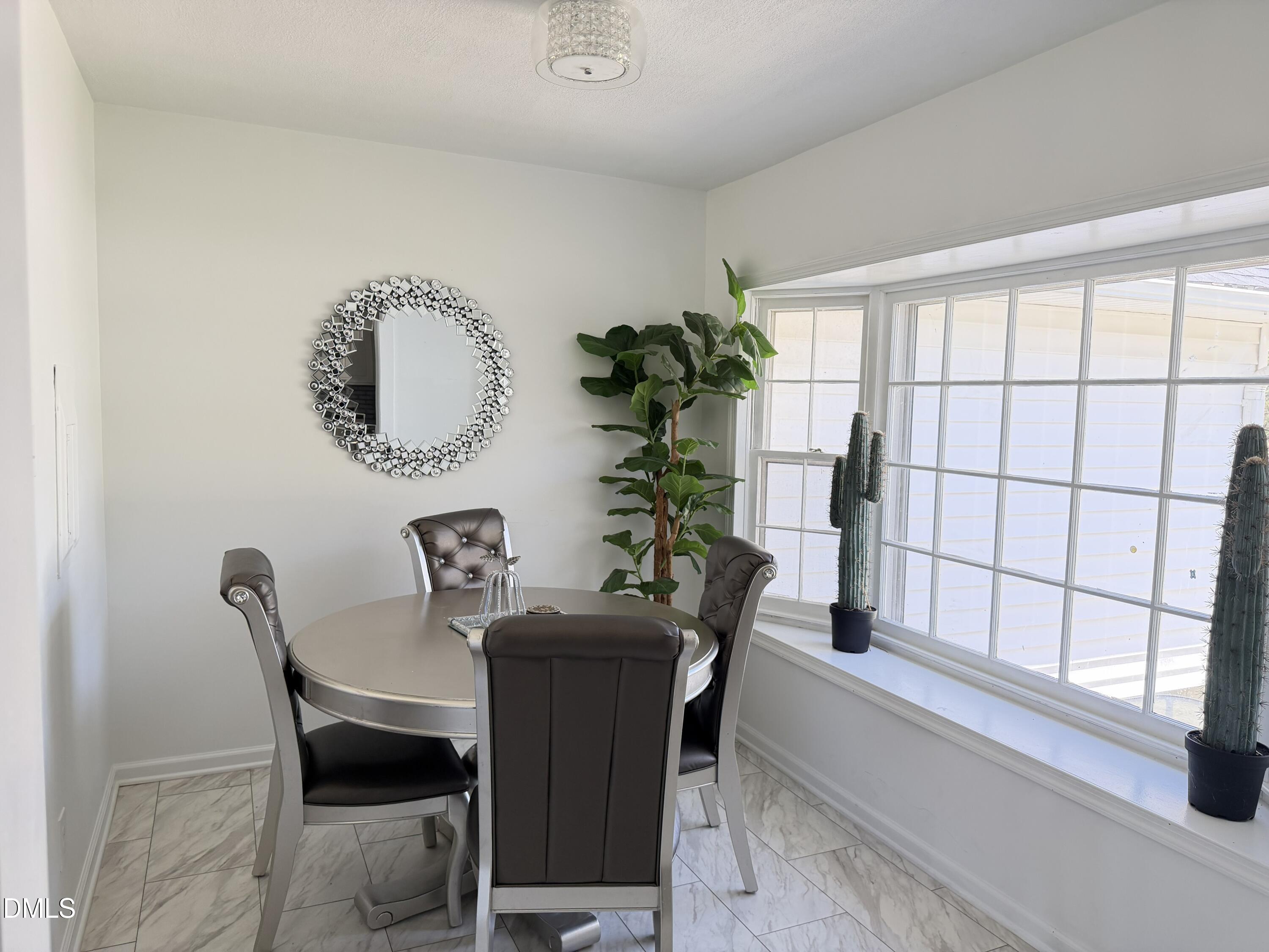 1899 Stewart Farm Road Henderson, NC 27537 - Photo 13 of 27 a dining room with furniture and window