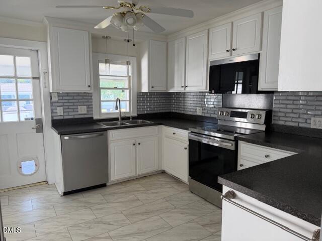 1899 Stewart Farm Road Henderson, NC 27537 - Photo 14 of 27 a kitchen with a sink stove and microwave