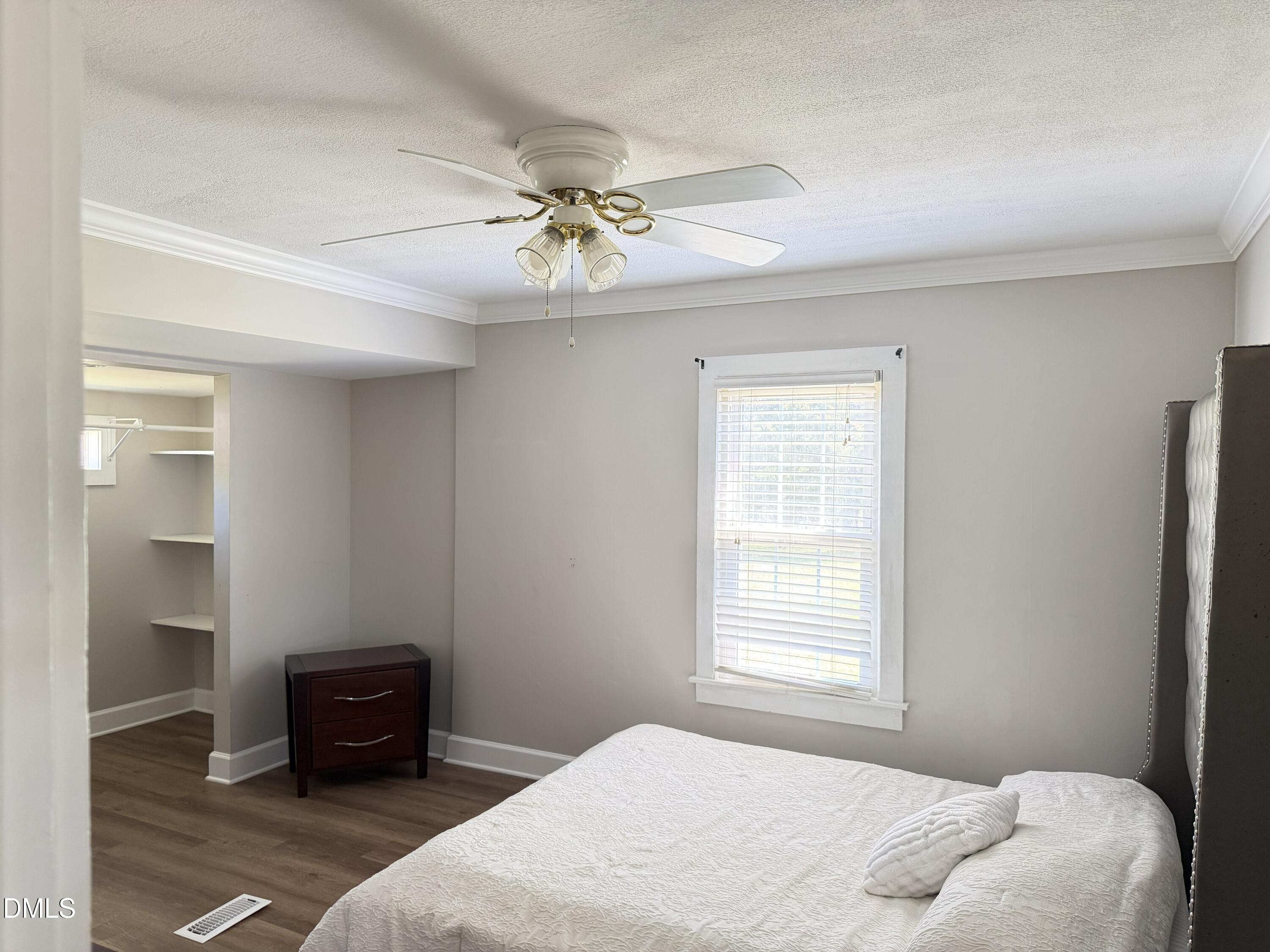 1899 Stewart Farm Road Henderson, NC 27537 - Photo 16 of 27 a bedroom with a bed and wooden floor