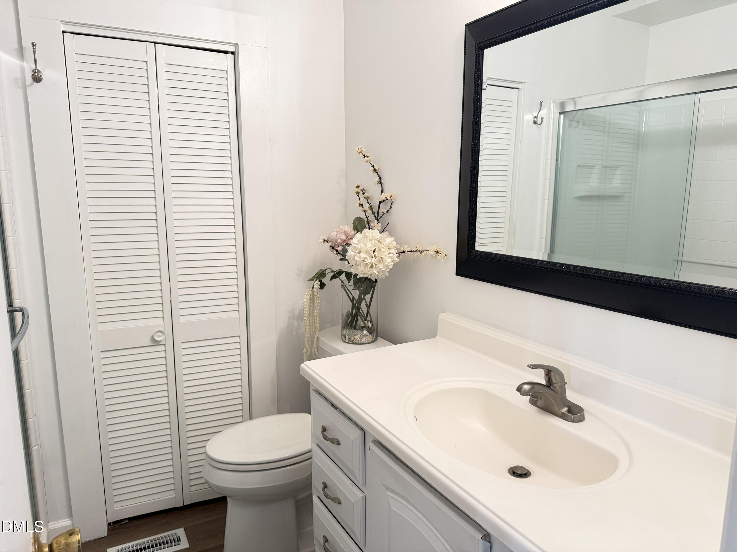 1899 Stewart Farm Road Henderson, NC 27537 - Photo 19 of 27 a bathroom with a sink toilet and mirror