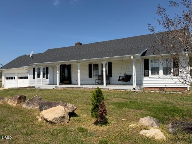 1899 Stewart Farm Road Henderson, NC 27537 - Photo 2 of 27 a front view of a house with a garden and porch
