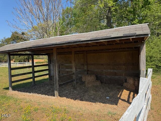 1899 Stewart Farm Road Henderson, NC 27537 - Photo 26 of 27 a wooden bench sitting in front of a building