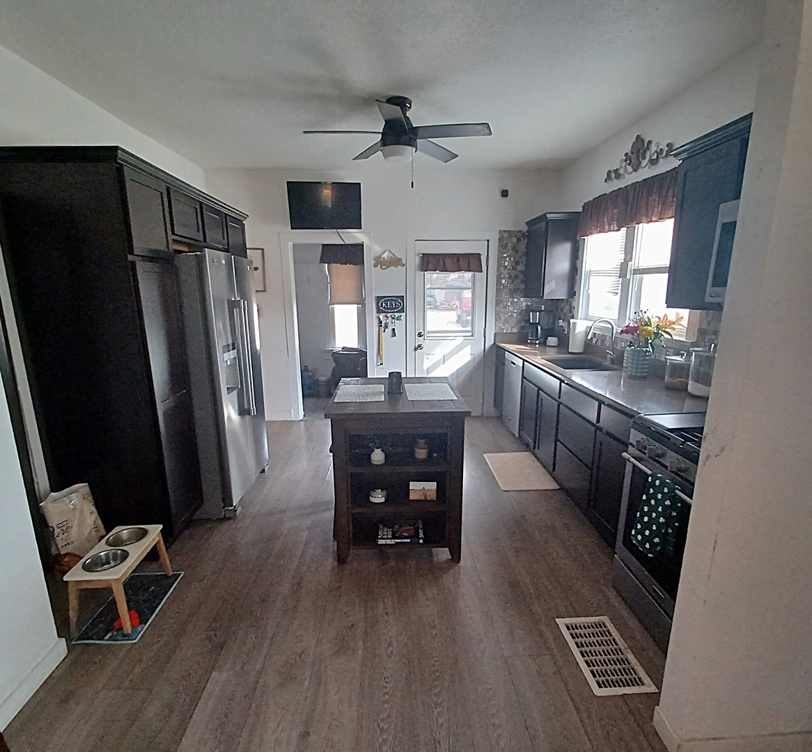 122 South Beach Street Kewanee, IL 61443 - Photo 26 of 49 a kitchen with a table chairs refrigerator and cabinets