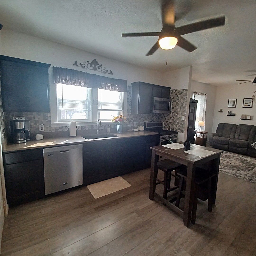 122 South Beach Street Kewanee, IL 61443 - Photo 32 of 49 a kitchen with a stove a sink and a refrigerator