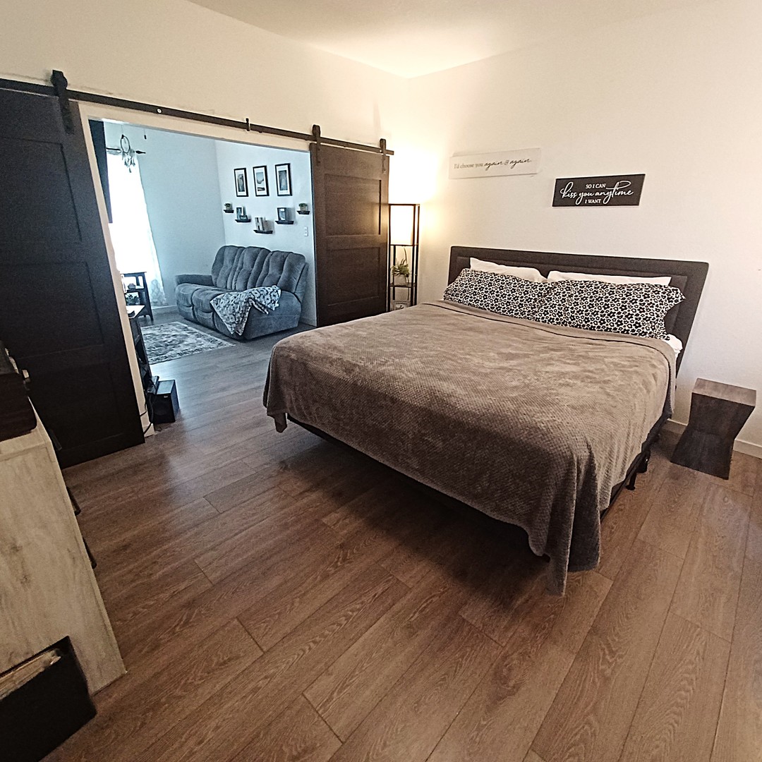 122 South Beach Street Kewanee, IL 61443 - Photo 40 of 49 a bedroom with a bed window and a flat screen tv