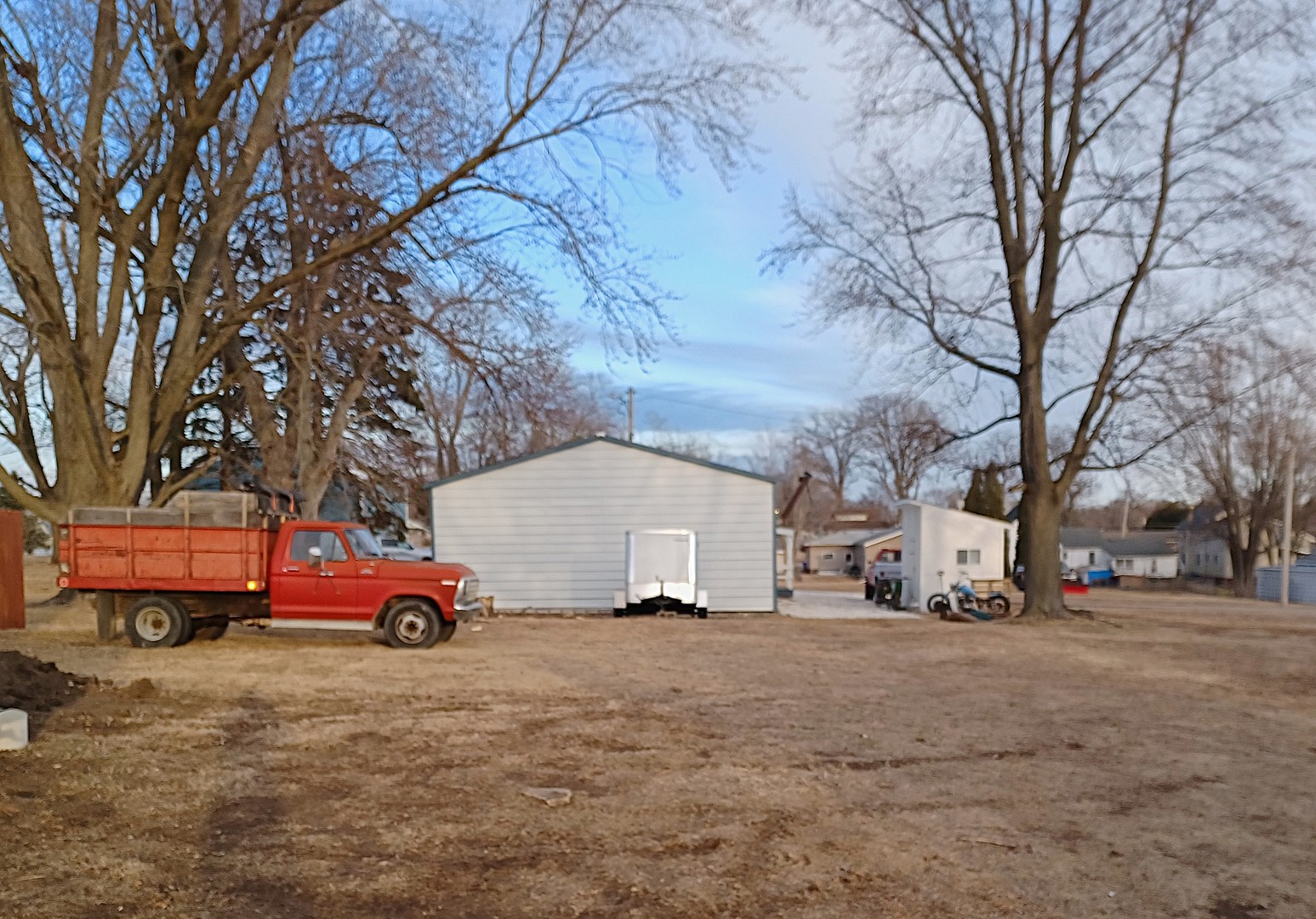 122 South Beach Street Kewanee, IL 61443 - Photo 7 of 49 a white house with a tree in front of it