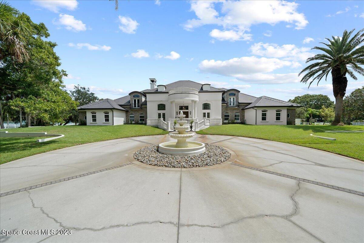 2815 Turtle Mound Road Melbourne, FL 32934 - Photo 101 of 115 a front view of a house with a garden and trees