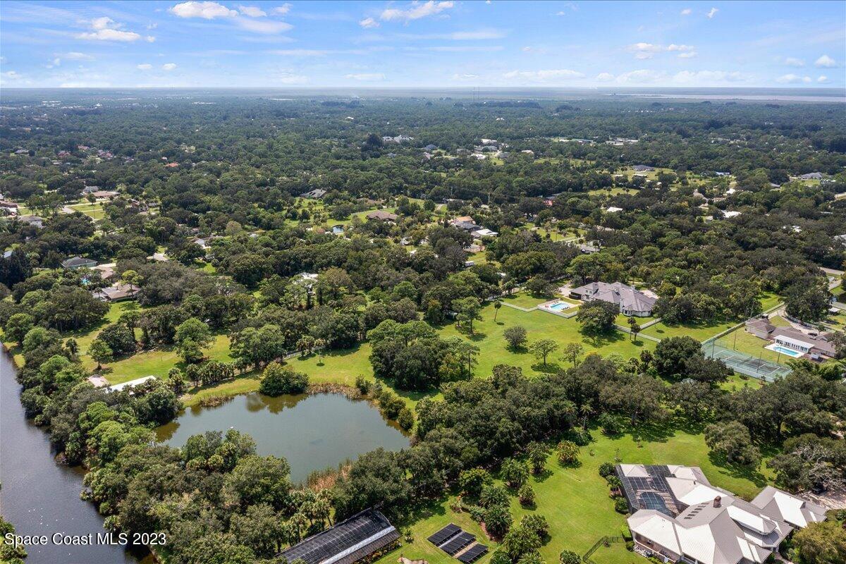 2815 Turtle Mound Road Melbourne, FL 32934 - Photo 108 of 115 an aerial view of residential houses with outdoor space and trees