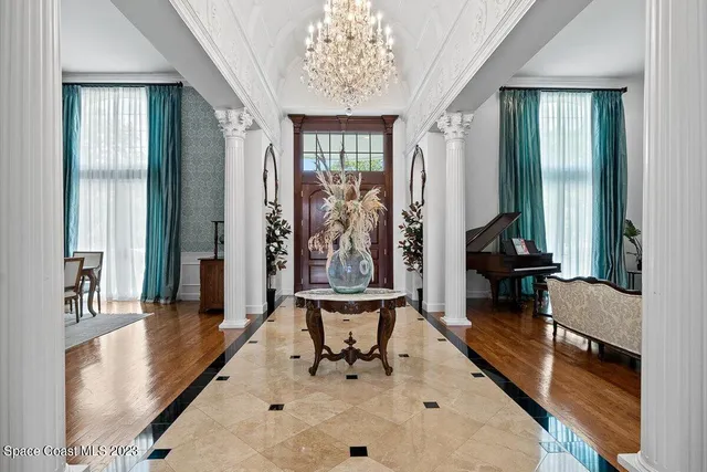 a living room with furniture a fireplace and a large window
