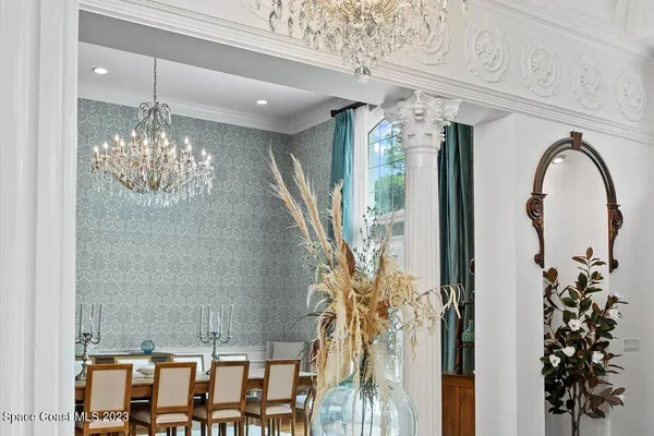 a living room with furniture a fireplace and a floor to ceiling window