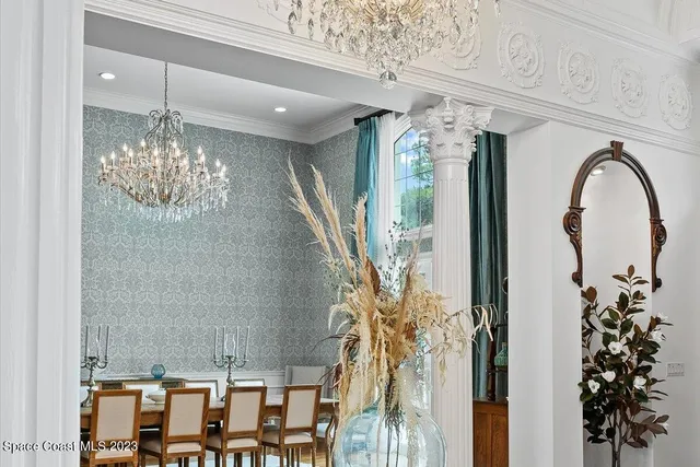 a living room with furniture a fireplace and a floor to ceiling window