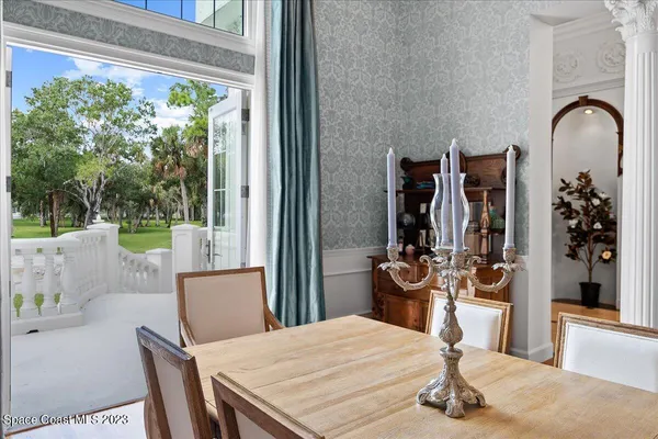 a living room with furniture chandelier and a large window