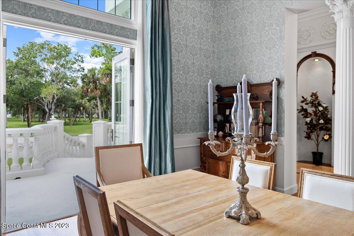 2815 Turtle Mound Road Melbourne, FL 32934 - Photo 16 of 115 a dining room with furniture and wooden floor