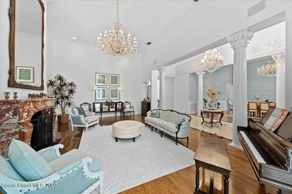 a dining room with furniture a rug and a large window