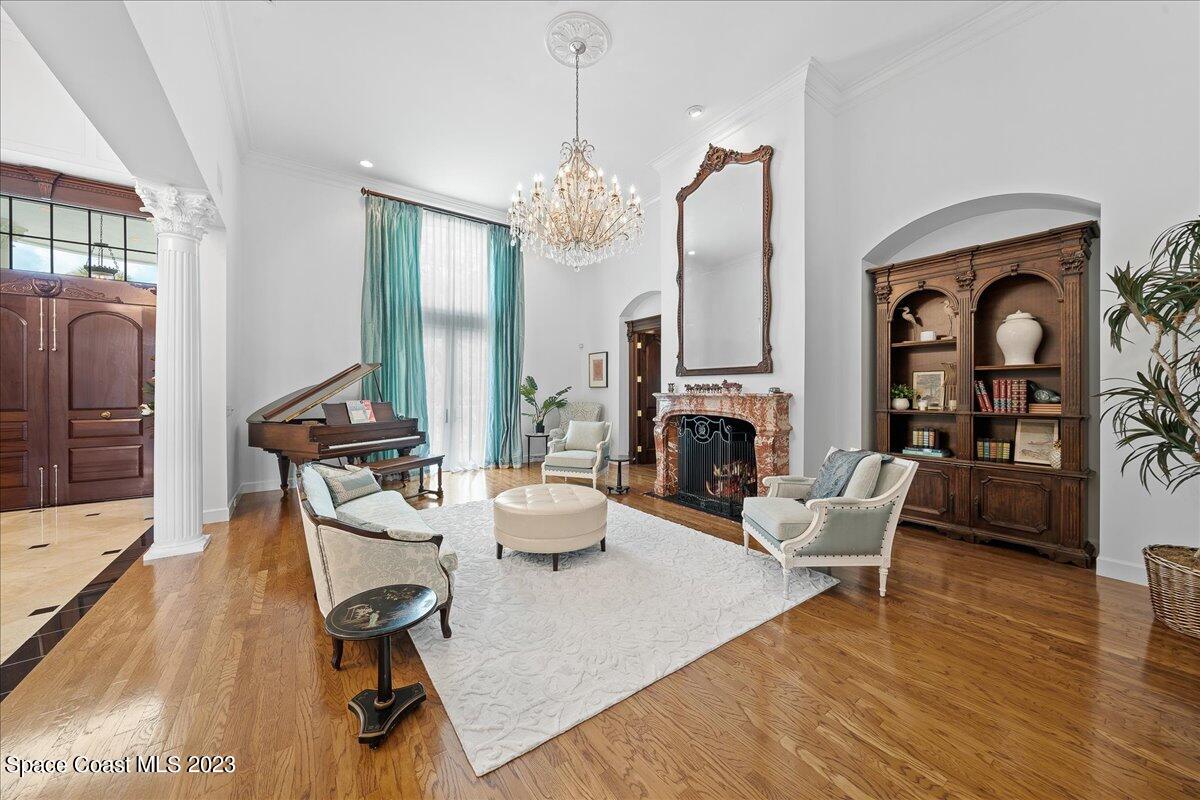 2815 Turtle Mound Road Melbourne, FL 32934 - Photo 21 of 115 a living room with fireplace furniture or chandelier and a wooden floor