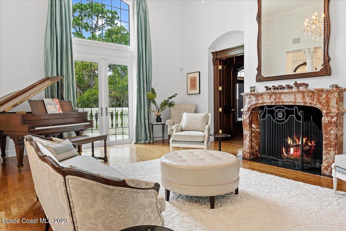 2815 Turtle Mound Road Melbourne, FL 32934 - Photo 22 of 115 a living room with furniture a fireplace and a large window