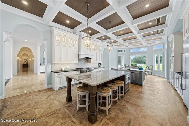 a bedroom with a large bed and a chandelier