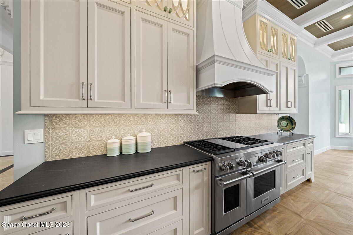 2815 Turtle Mound Road Melbourne, FL 32934 - Photo 30 of 115 a kitchen with granite countertop stainless steel appliances a stove and a white cabinets