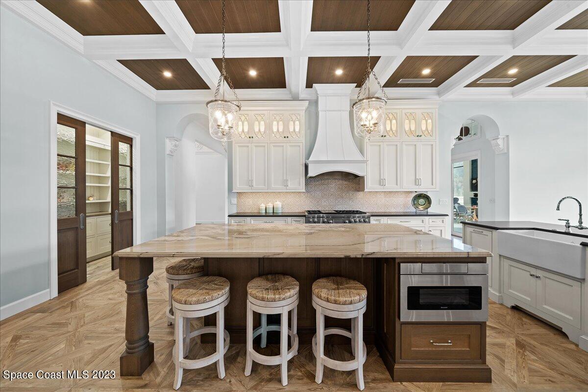 2815 Turtle Mound Road Melbourne, FL 32934 - Photo 31 of 115 a kitchen with stainless steel appliances granite countertop wooden cabinets and a stove top oven