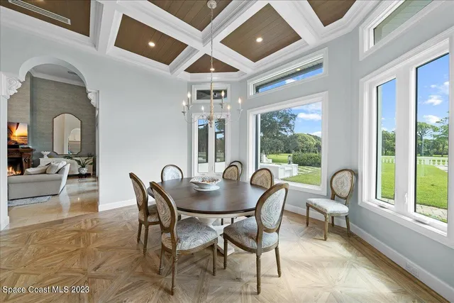 an empty room with windows and ceiling fan
