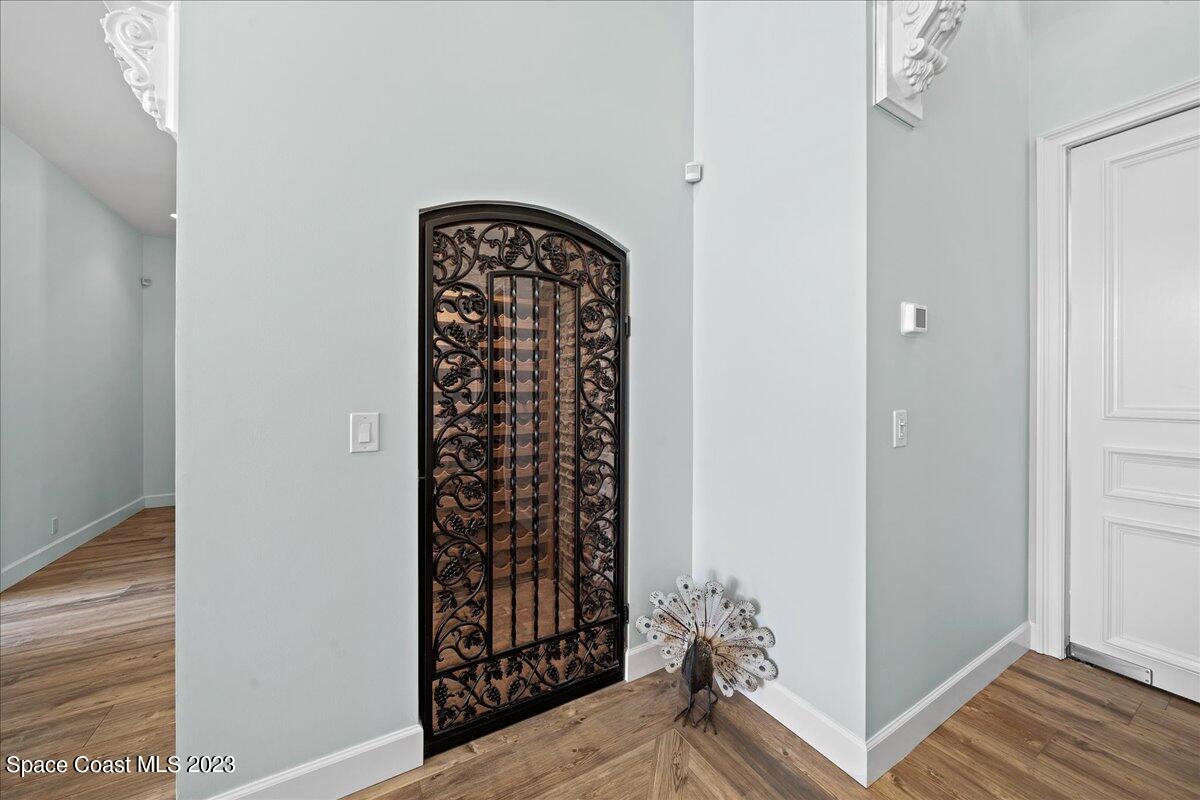 2815 Turtle Mound Road Melbourne, FL 32934 - Photo 35 of 115 a view of a hallway with wooden floor and a potted plant