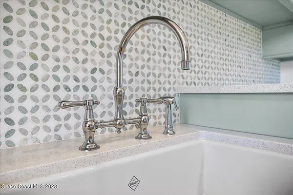 a view of a patio with a table and chairs