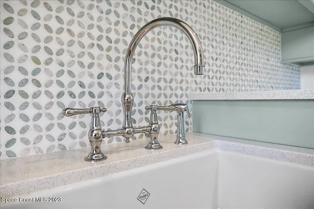 a view of a patio with a table and chairs