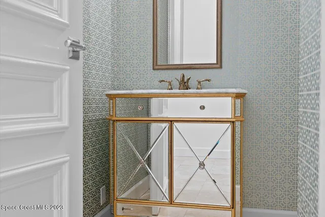 a front view of a house with a garden and trees