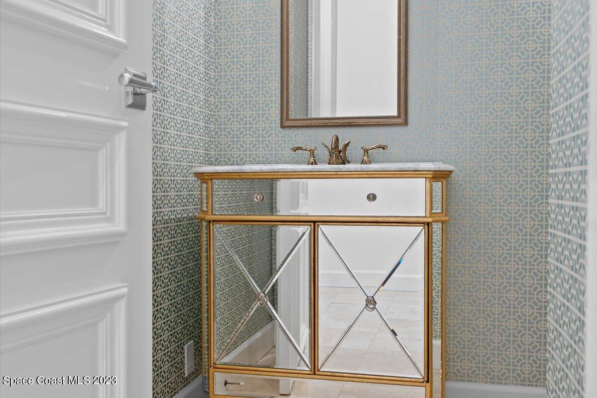 2815 Turtle Mound Road Melbourne, FL 32934 - Photo 41 of 115 a bathroom with a sink a mirror and a shower curtain