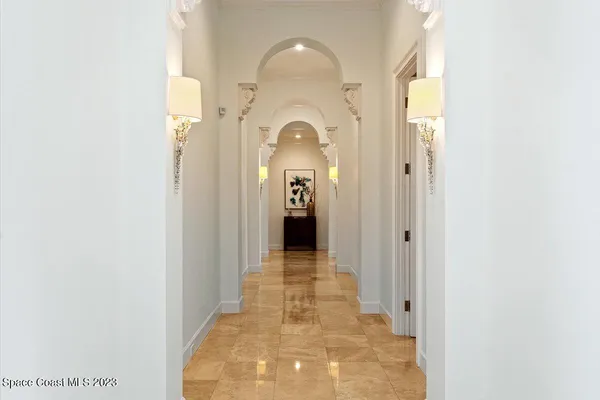 a front view of a house with a yard and lake view