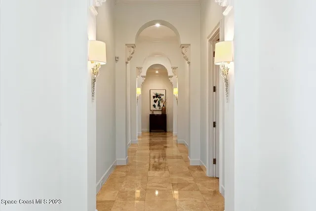 a front view of a house with a yard and lake view