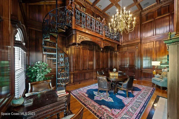 a view of a house with a big yard and palm trees
