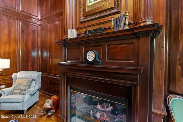 a front view of a house with a garden and trees