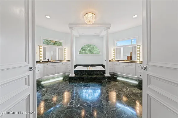 an aerial view of residential houses with outdoor space and trees