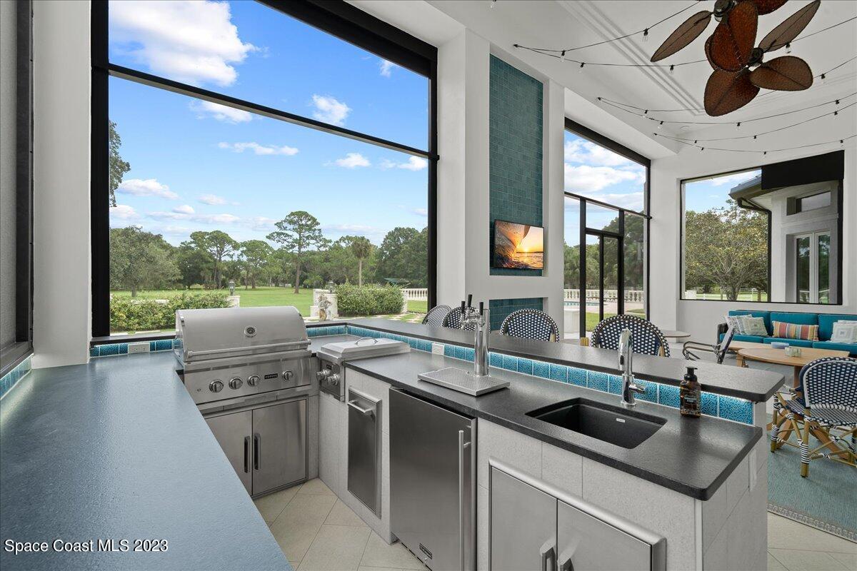 2815 Turtle Mound Road Melbourne, FL 32934 - Photo 58 of 115 a kitchen with stainless steel appliances granite countertop a sink a stove and a wooden floors